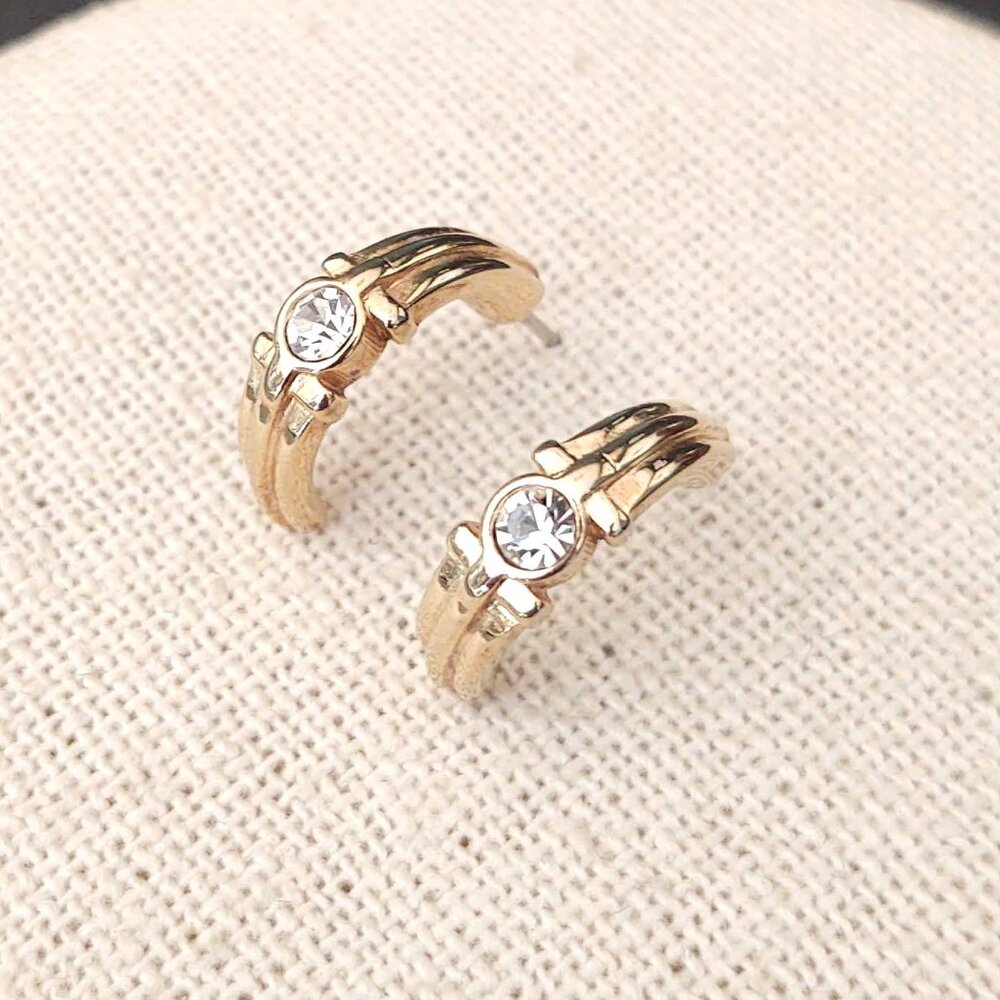 Curved gold tone earrings with faux diamond centers